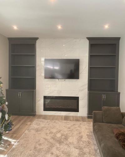 After - Fireplace with custom wall cabinetry and shelves