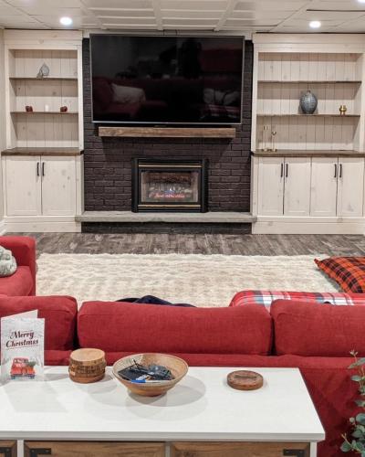 Living room fireplace with custom wall cabinetry and shelving