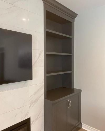 After - Fireplace with custom wall cabinetry and shelves (right)